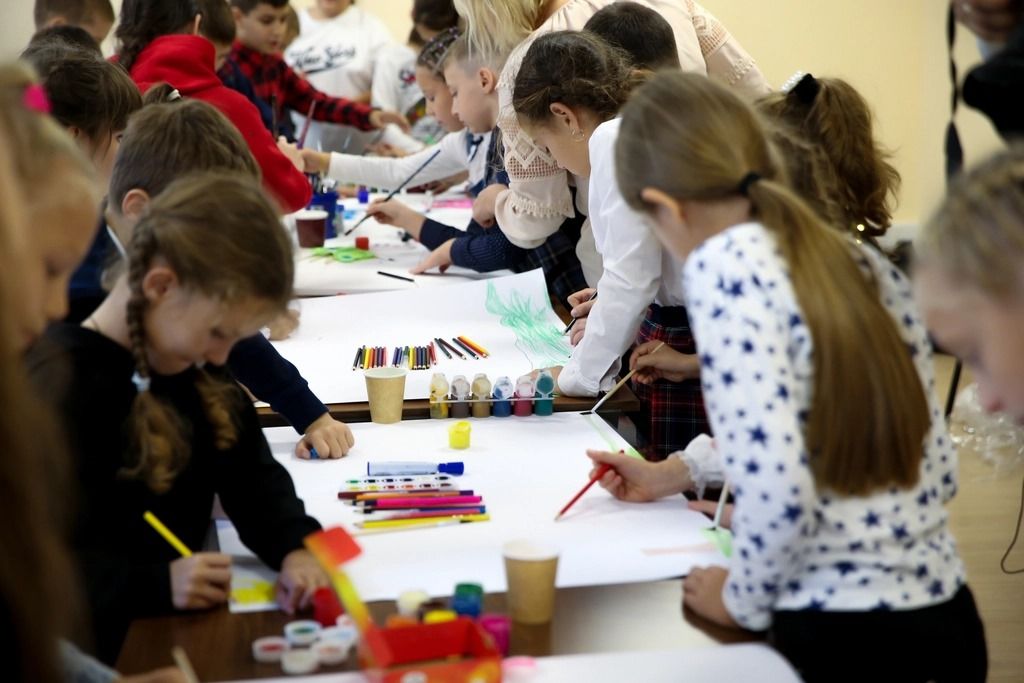 Pupils painting together in an art class